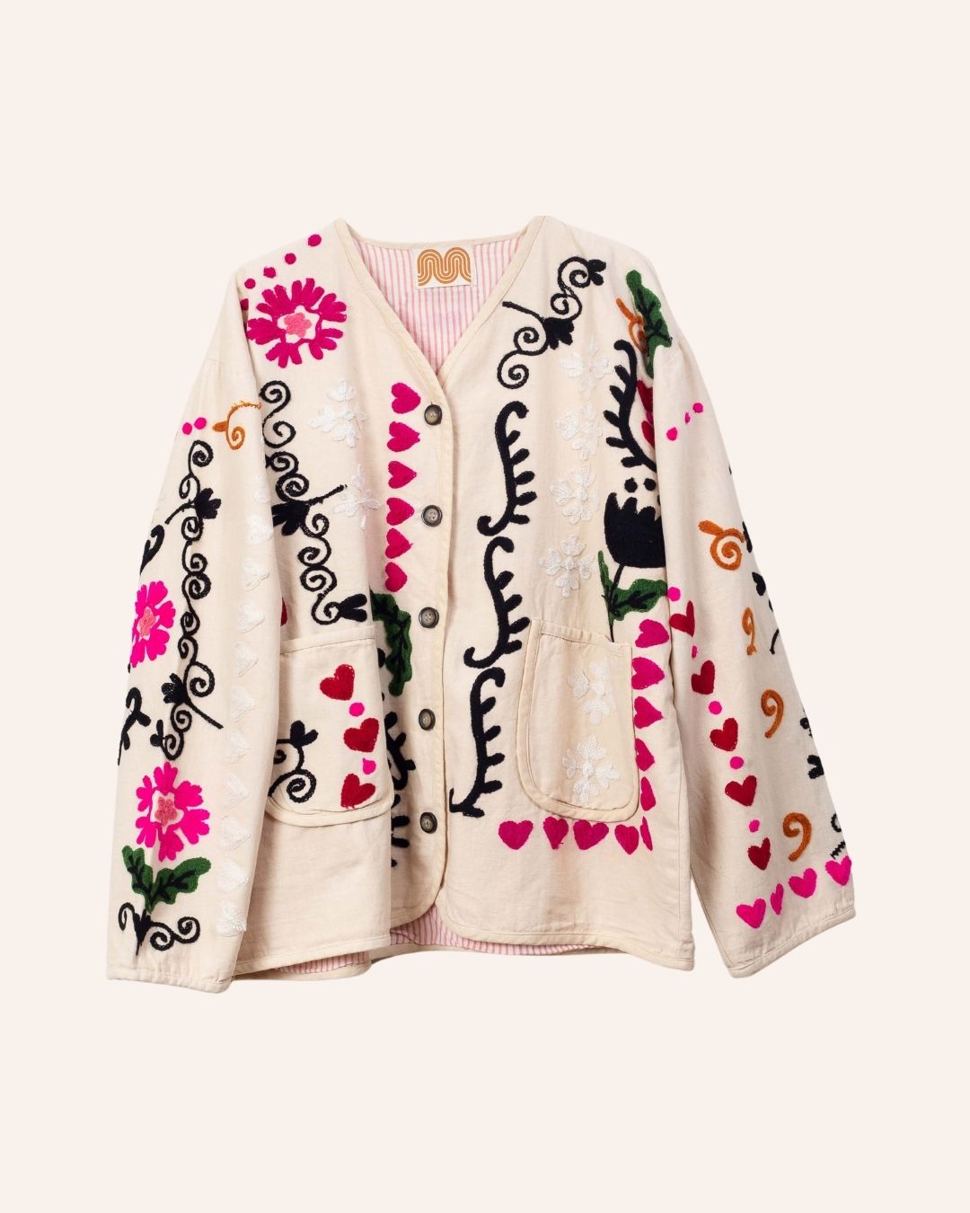 Cream cotton jacket hand-embroidered with black peacock, pink florals, red hearts, and swirling folk-style vines.